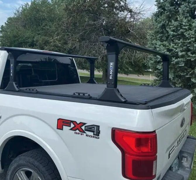 Elevate truck ladder rack installed on bed of white F150 truck