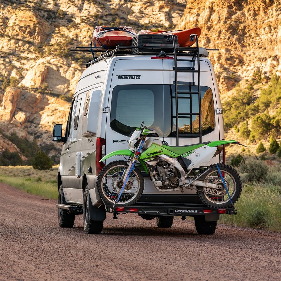 VersaHaul Single Motorcycle Carrier with ramp on back of Winnebago driving down road