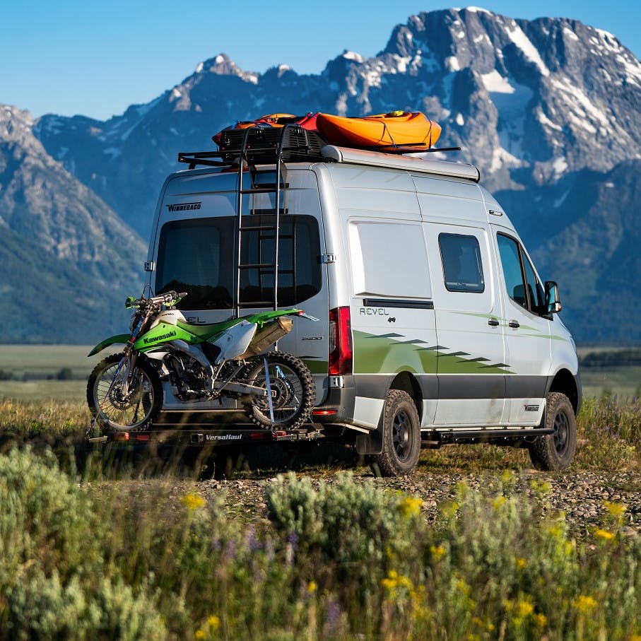 VersaHaul Single Motorcycle Carrier with ramp on back of winnebago near mountains